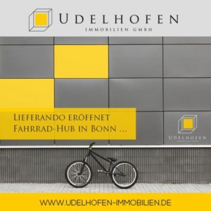 Fahrrad vor gelber Wand mit Lieferando-Text.
