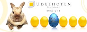Frohe Ostern von Udelfofen Immobilien mit Hase und Eiern.